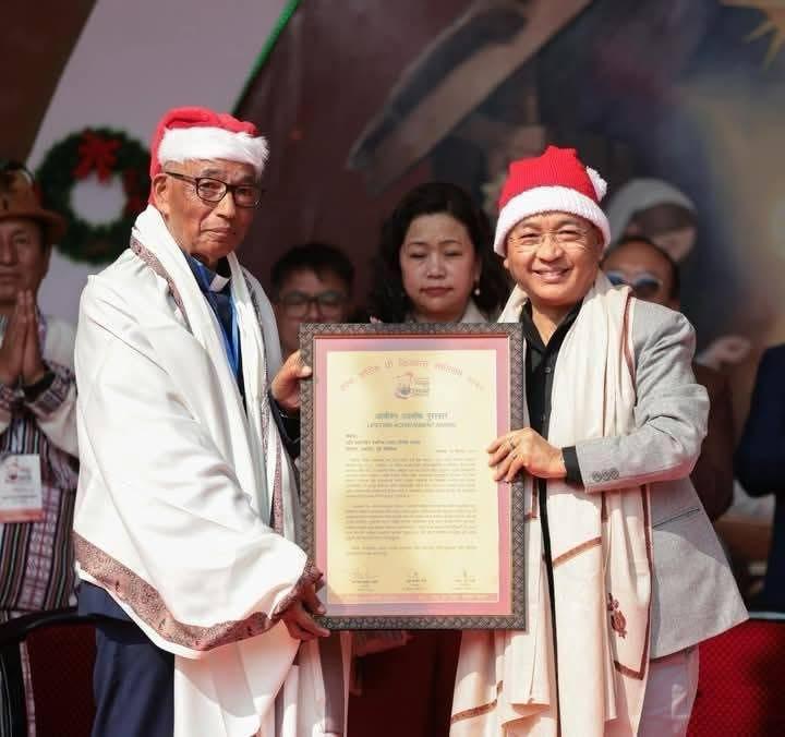 Rev. Joseph Tamang receiving award from Chief Minister